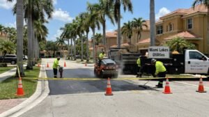 Miami Lakes Plumbing service truck with operators actively repairing a broken underground water pipe on a local street
